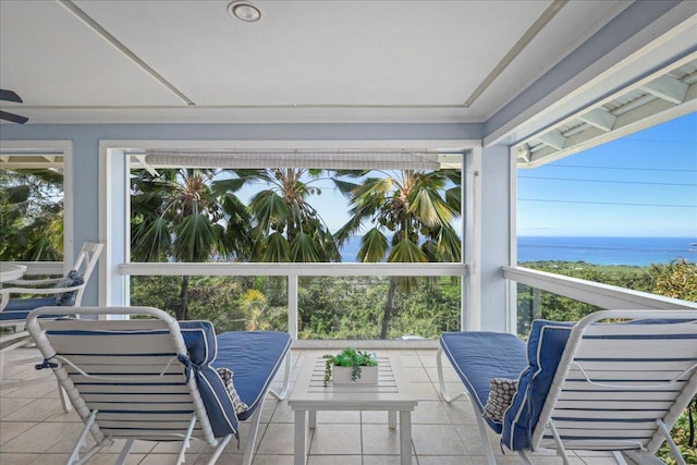 sunroom featuring a water view