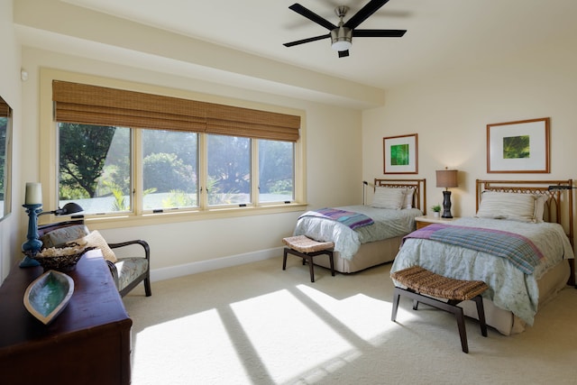 bedroom featuring light colored carpet and ceiling fan