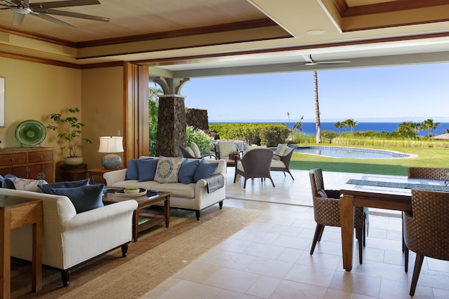 living room with a water view, ceiling fan, and ornamental molding