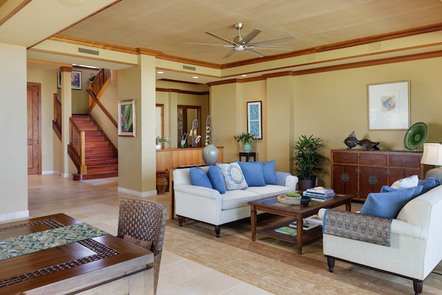 living room featuring a raised ceiling, ceiling fan, light hardwood / wood-style floors, and ornamental molding