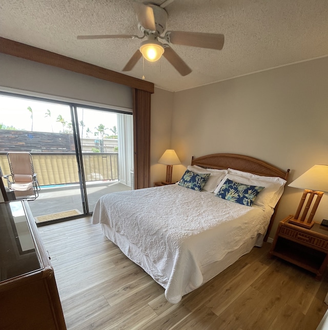 bedroom with access to exterior, hardwood / wood-style floors, a textured ceiling, and ceiling fan