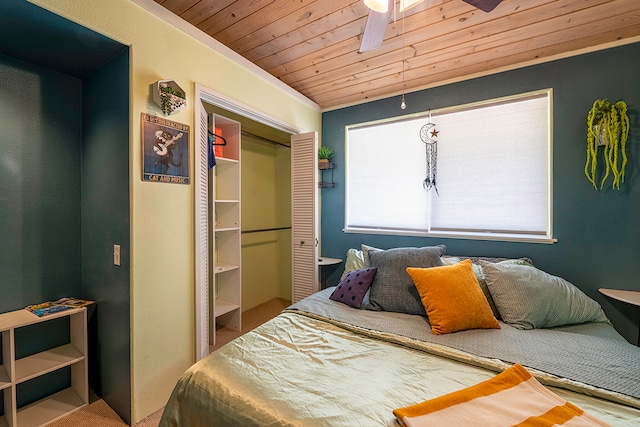 bedroom featuring ceiling fan, a closet, and wood ceiling