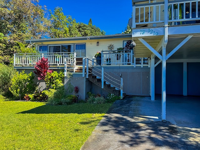 view of front facade with a carport and a front yard