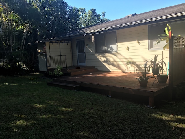 back of property featuring a yard and a wooden deck