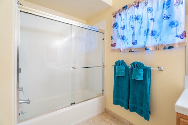 bathroom with tile patterned floors and combined bath / shower with glass door