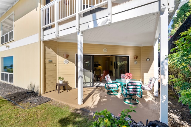 rear view of house with a balcony and a patio