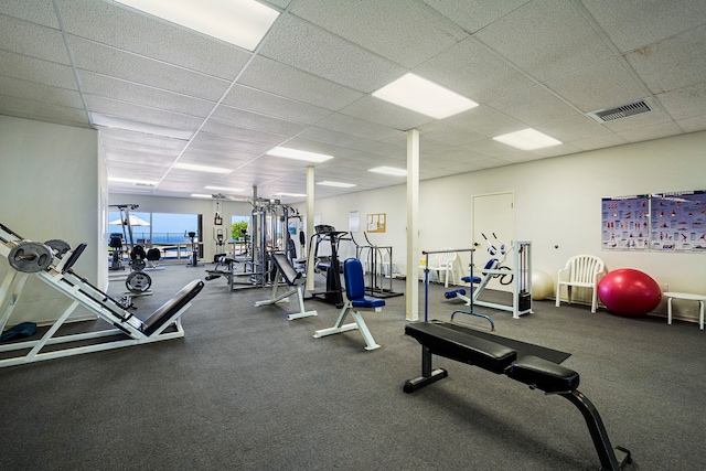 workout area with a paneled ceiling