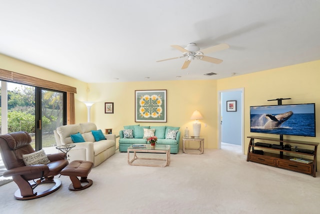 carpeted living room featuring ceiling fan and french doors