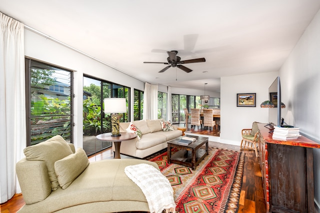 living room with hardwood / wood-style flooring, ceiling fan, and a healthy amount of sunlight