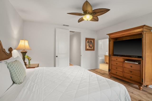 bedroom with ceiling fan, ensuite bathroom, and hardwood / wood-style flooring