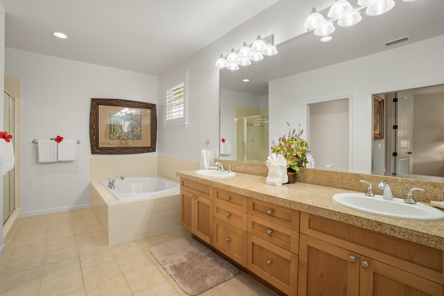 bathroom with tile patterned flooring, shower with separate bathtub, and vanity