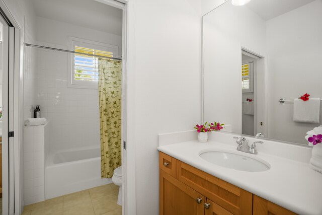 full bathroom with tile patterned flooring, shower / tub combo, vanity, and toilet