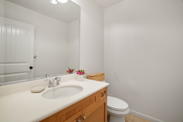 bathroom featuring tile patterned flooring, vanity, and toilet