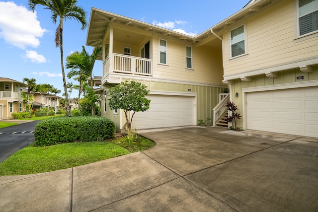 view of front of house featuring a garage and a balcony