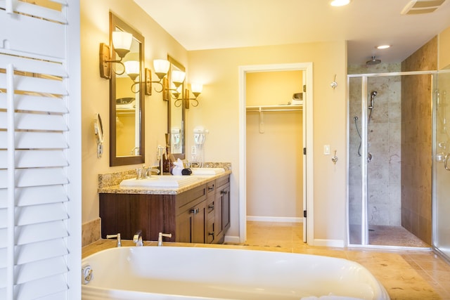 bathroom featuring tile patterned flooring, vanity, and a shower with door