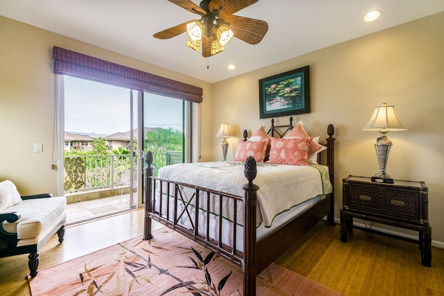 bedroom featuring hardwood / wood-style flooring, ceiling fan, and access to outside