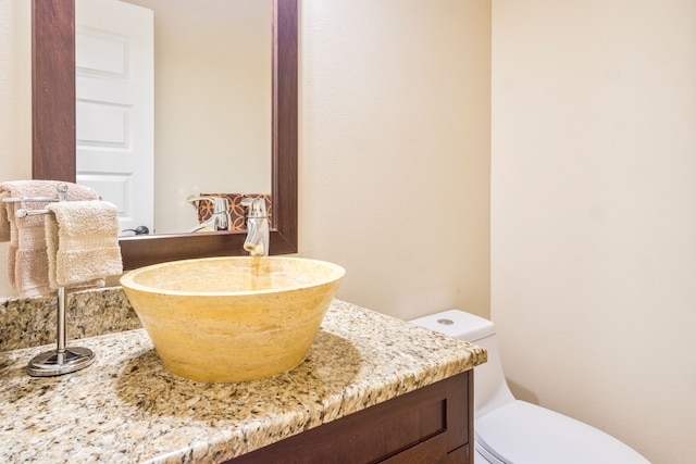 bathroom featuring vanity and toilet