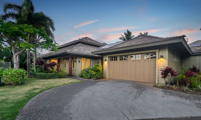 view of front facade with a garage and a yard