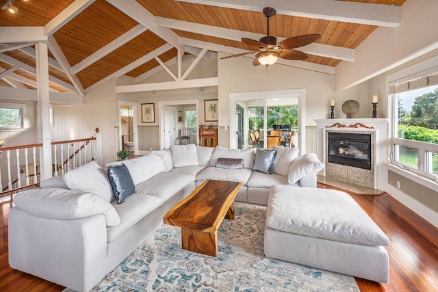 living room featuring high vaulted ceiling, a healthy amount of sunlight, and hardwood / wood-style flooring