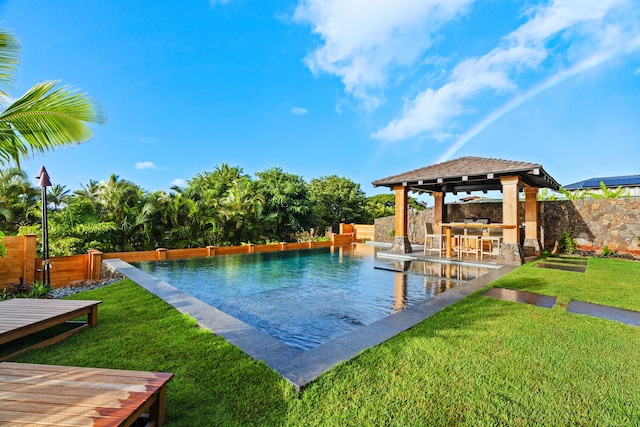 view of pool with a gazebo, a yard, and an outdoor bar