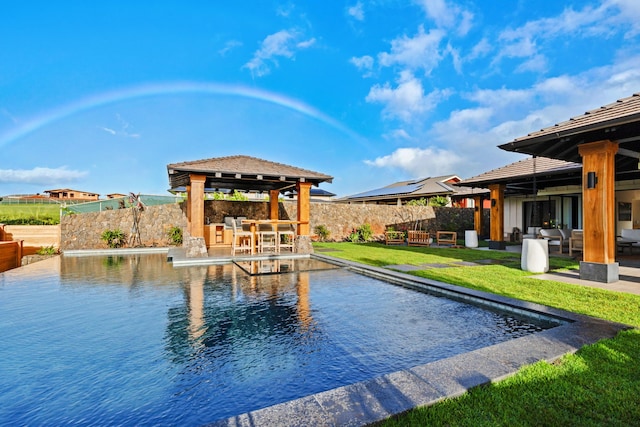 view of swimming pool featuring a gazebo, a patio, and an outdoor bar