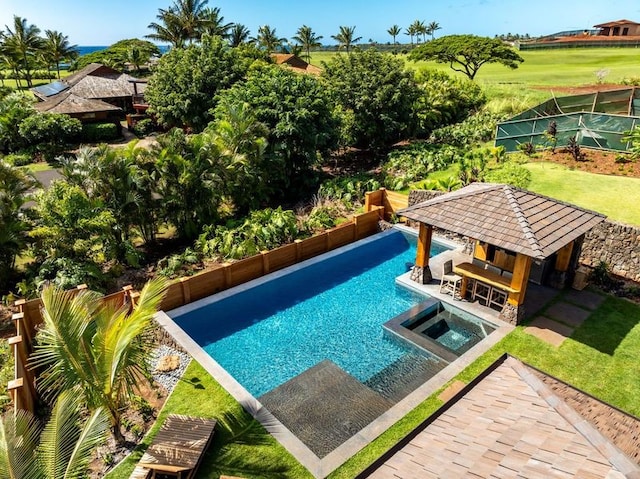 view of swimming pool with an in ground hot tub, a gazebo, and exterior bar