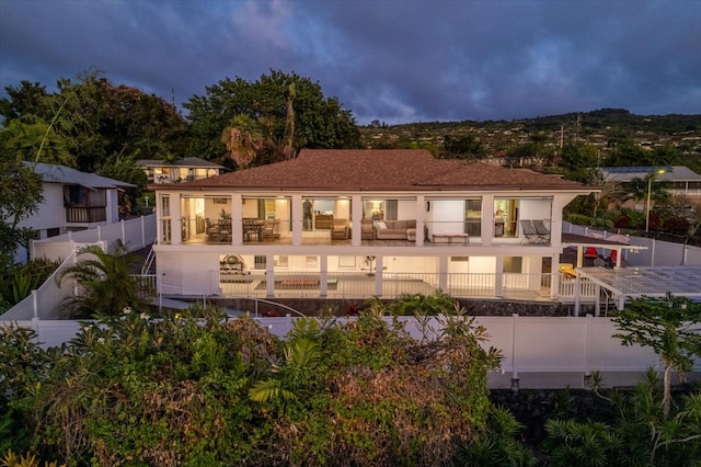 back of property with a balcony