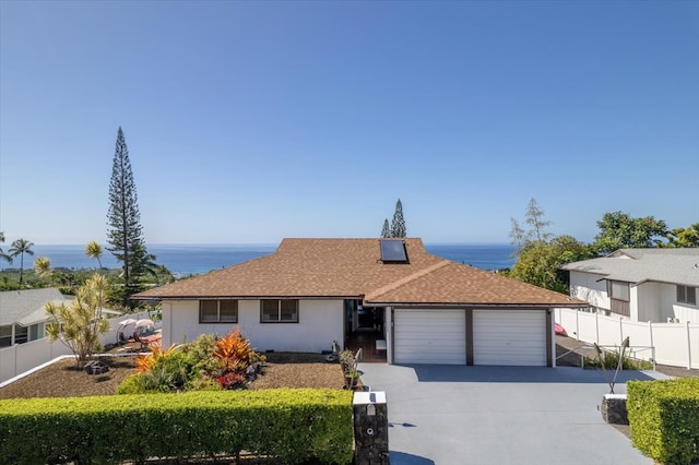 ranch-style house featuring a water view and a garage