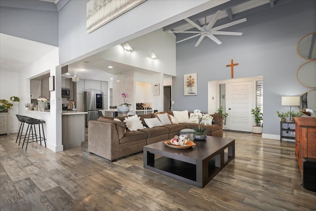 living room with beamed ceiling, high vaulted ceiling, ceiling fan, and dark wood-type flooring