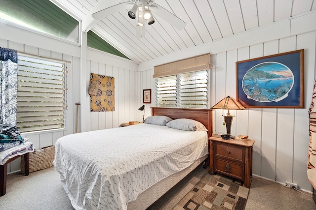 bedroom with wooden walls, vaulted ceiling, carpet flooring, ceiling fan, and wood ceiling