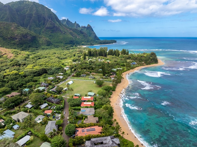 aerial view featuring a water and mountain view and a beach view