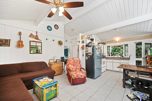 living room featuring sink, light tile patterned flooring, and lofted ceiling with beams