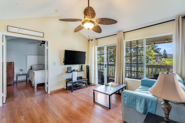 living room featuring hardwood / wood-style flooring, ceiling fan, and lofted ceiling