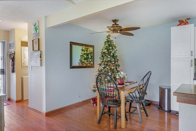 dining room with ceiling fan, wood-type flooring, and a textured ceiling