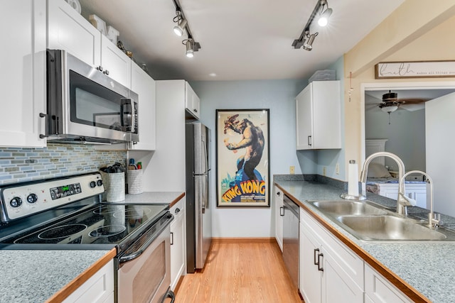 kitchen featuring light hardwood / wood-style floors, sink, white cabinetry, and stainless steel appliances