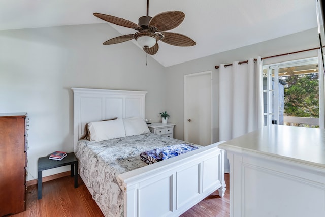 bedroom with ceiling fan, lofted ceiling, and hardwood / wood-style flooring