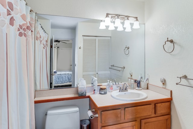 bathroom with ceiling fan, vanity, and toilet