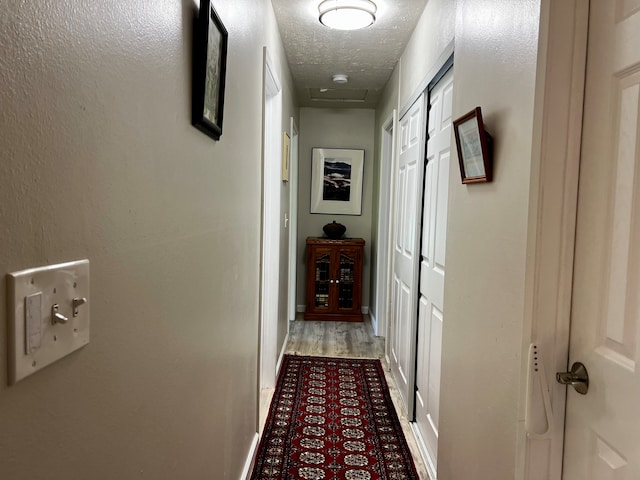 corridor with light hardwood / wood-style floors