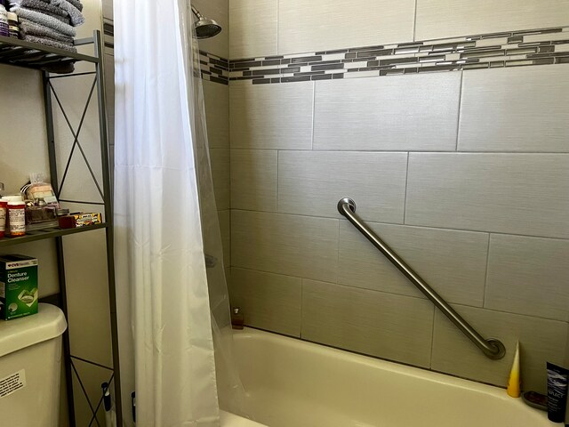 bathroom with shower / bath combination with curtain