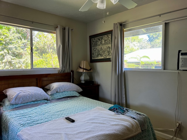 bedroom featuring ceiling fan and multiple windows