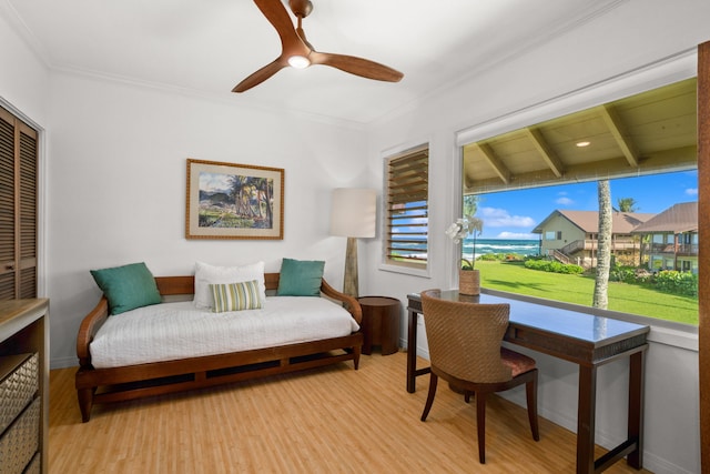 bedroom featuring ceiling fan, a closet, ornamental molding, and light hardwood / wood-style flooring