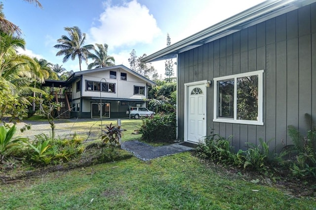 doorway to property with a yard