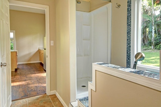 bathroom featuring a shower, vanity, and wood-type flooring