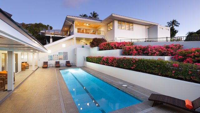 back house at dusk with a patio