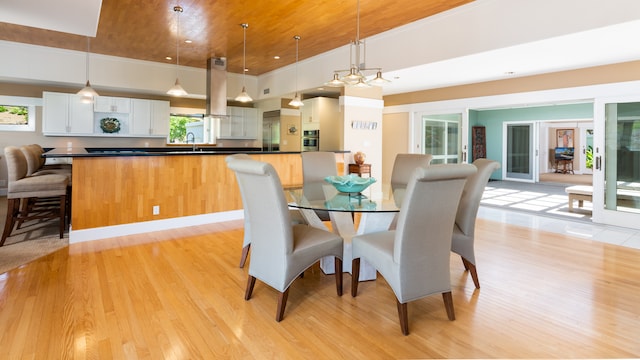 dining space with sink and light hardwood / wood-style floors