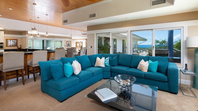 carpeted living room featuring wooden ceiling