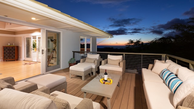 deck at dusk with outdoor lounge area