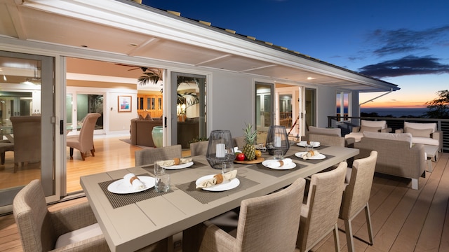 deck at dusk featuring outdoor lounge area