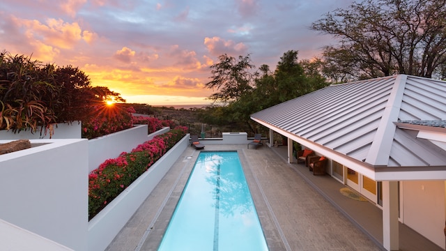 view of pool at dusk