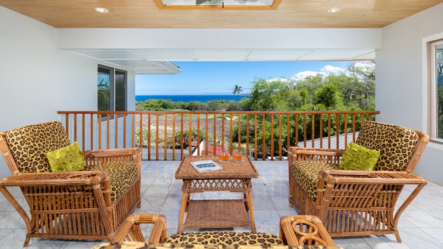 balcony featuring a water view and a patio